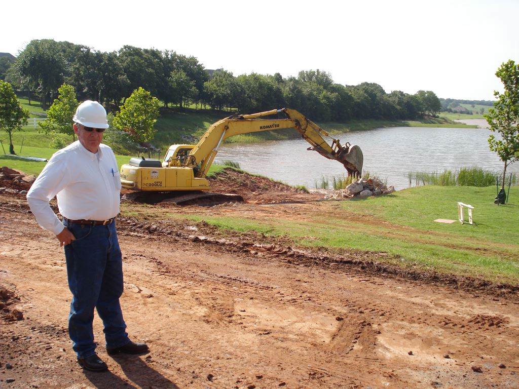 Man poses in front of construction site